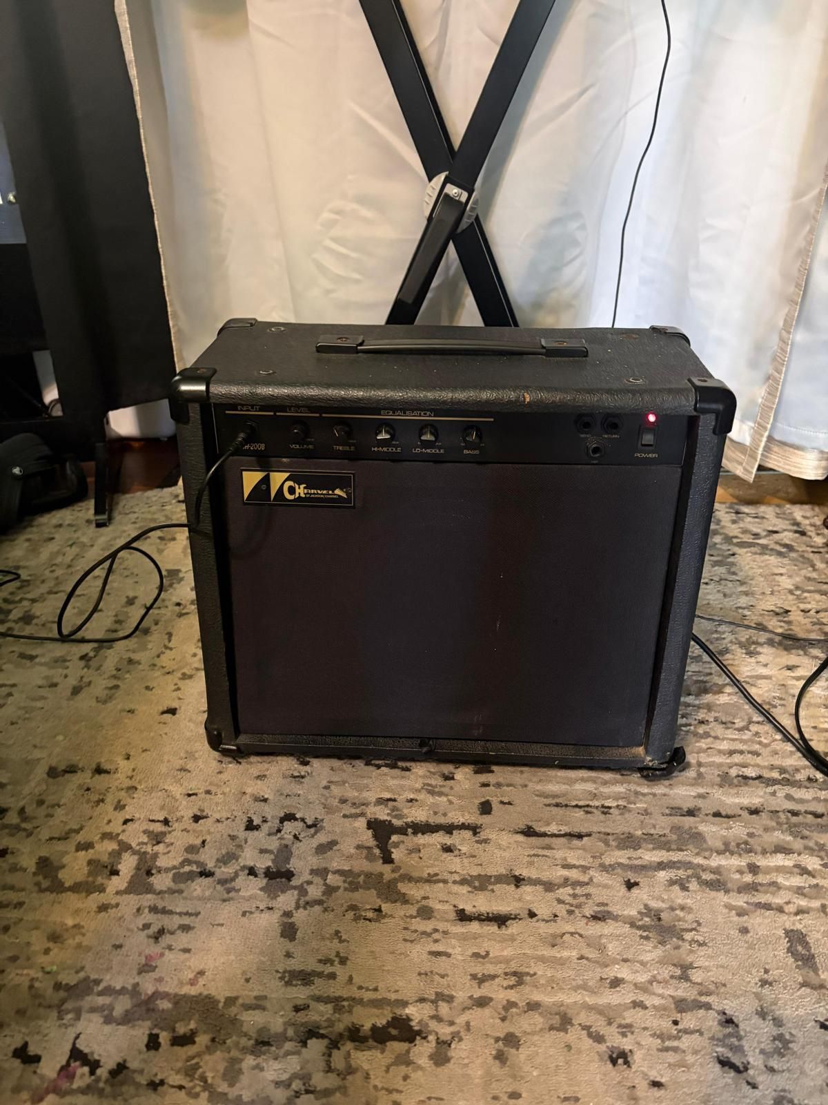 Charvel CH-200B bass amplifier. It is a solid-state combo amp with a 20-watt output and a single 8-inch speaker. It was manufactured in the early to