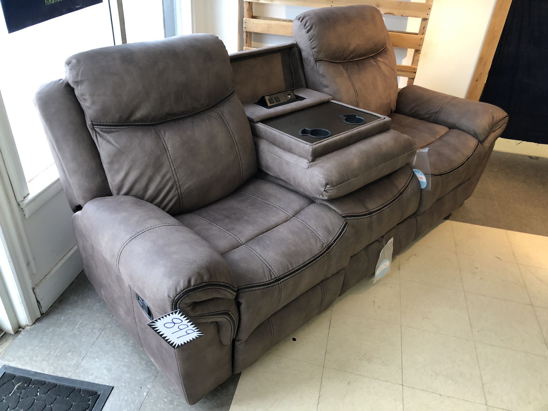 WATER RESISTANT Microfiber smooth bomber jacket material recliner. Pull out table with cup holders. Built in USB ports and wall plug ins. Hidden draw