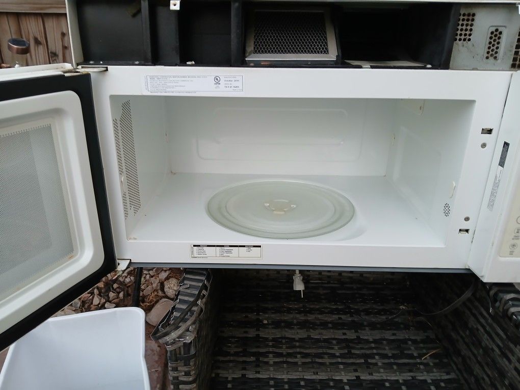 white Whirlpool over-the-range microwave, 