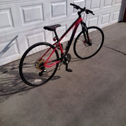 Specialized Cross Trail 28 in Wheels/700cc Hybrid. 21 Speed. Left Side 3 Speed Shifter Needs Adjusting . Deep Red Color in Very Nice Condition.
