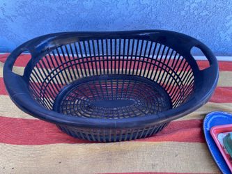 black plastic laundry basket with built-in handles and a lattice design