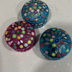 3 decorated small containers.