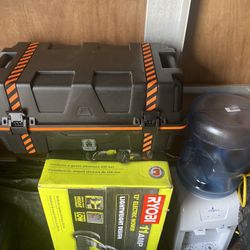 Brand new lawnmower and a sealed to Keith and a water dispenser with jug make a