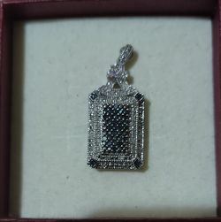 Sterling silver pendant with blue and white diamonds