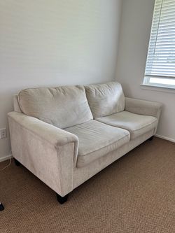 Deep seated beige loveseat couch