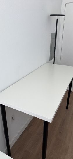 White stand up desk with adjustable legs