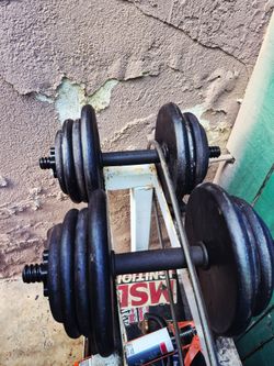 A pair of adjustable 45lb dumbbells 90lbs of weights total