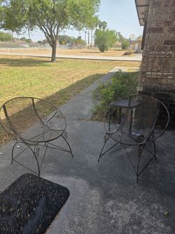 Two metal chairs and two metal end tables