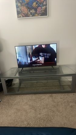 Will negotiate Grey tv stand and tv for sale