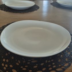 Six white West elm organic porcelain dinner plates and four placemats