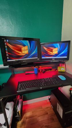 PC with keyboard and 2 monitors