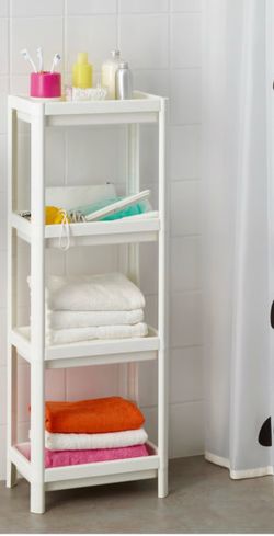 Versatile 4-tier shelving unit is made of durable white plastic. This IKEA VESKEN model has four rectangular shelves with perforated bases for drainag