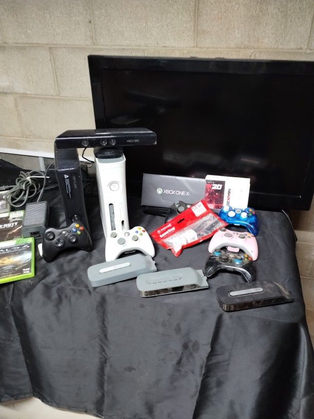 Two Xbox 360s Games And TVs