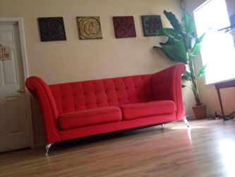 Red tuffed Chesterfield couch