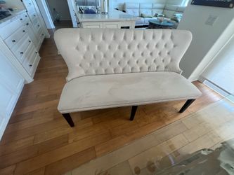 Cream colored velvet loveseat.