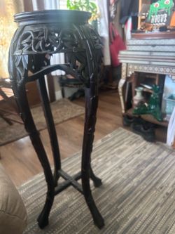 Tall corner table for vase with flowers