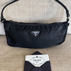 Prada Shoulder bag in canvas . It is a small bag in black 