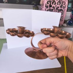 Copper colored double-arm candle holder