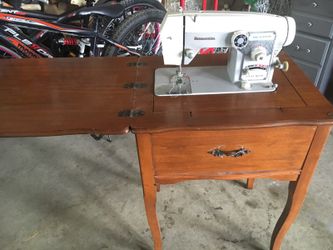 Antique sewing machine in wooden frame