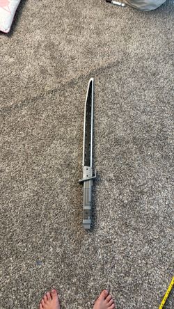 Hasbro Star Wars Mandalorian Darksaber electronic toy featuring white edges and a dark patterned blade.