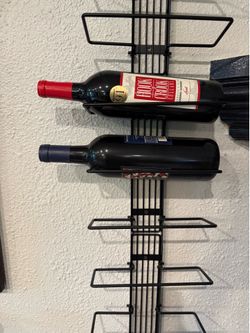 Wall-mounted metal wine rack / wine bottle organizer.