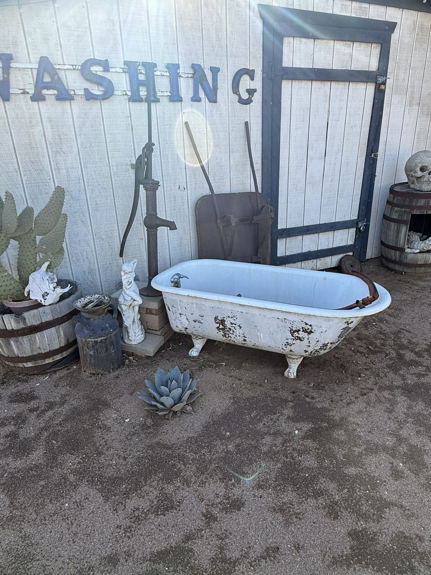 Vintage Cast-Iron Bathtub And Water Pump