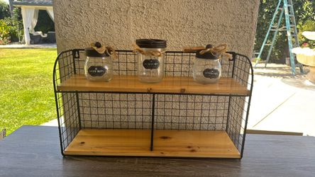 rustic farmhouse-style wall shelf features a black metal wire frame