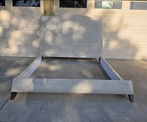 Like new beautiful eastern king upholstered bedframe (metal railing not included)