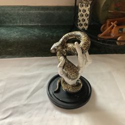 CHRISTIAN LACROIX Halloween Decor Skeleton Hand Holding Gold Snake approximately 10” tall