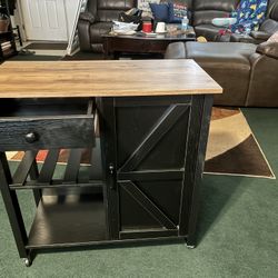 $120-cute medium size kitchen island- or small side table- (has wheels)-Measurements are Approximately 32" long X 16" Deep X 2'8" Tall. Besides a litt