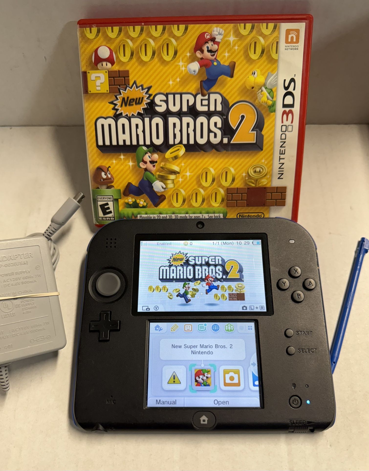 Nintendo 2DS Black and Blue console comes with an original stylus, an OEM charger, and a bonus game called New Super Mario Bros. 2, along with a 4GB