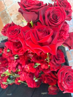 Bucket full of roses and carnations