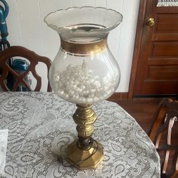 vintage hurricane candle holder featuring a brass base and a clear glass shade with a ruffled top