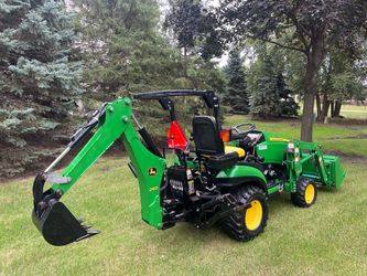 John Deere 1026R compact diesel with a backhoe and loader bucket.
