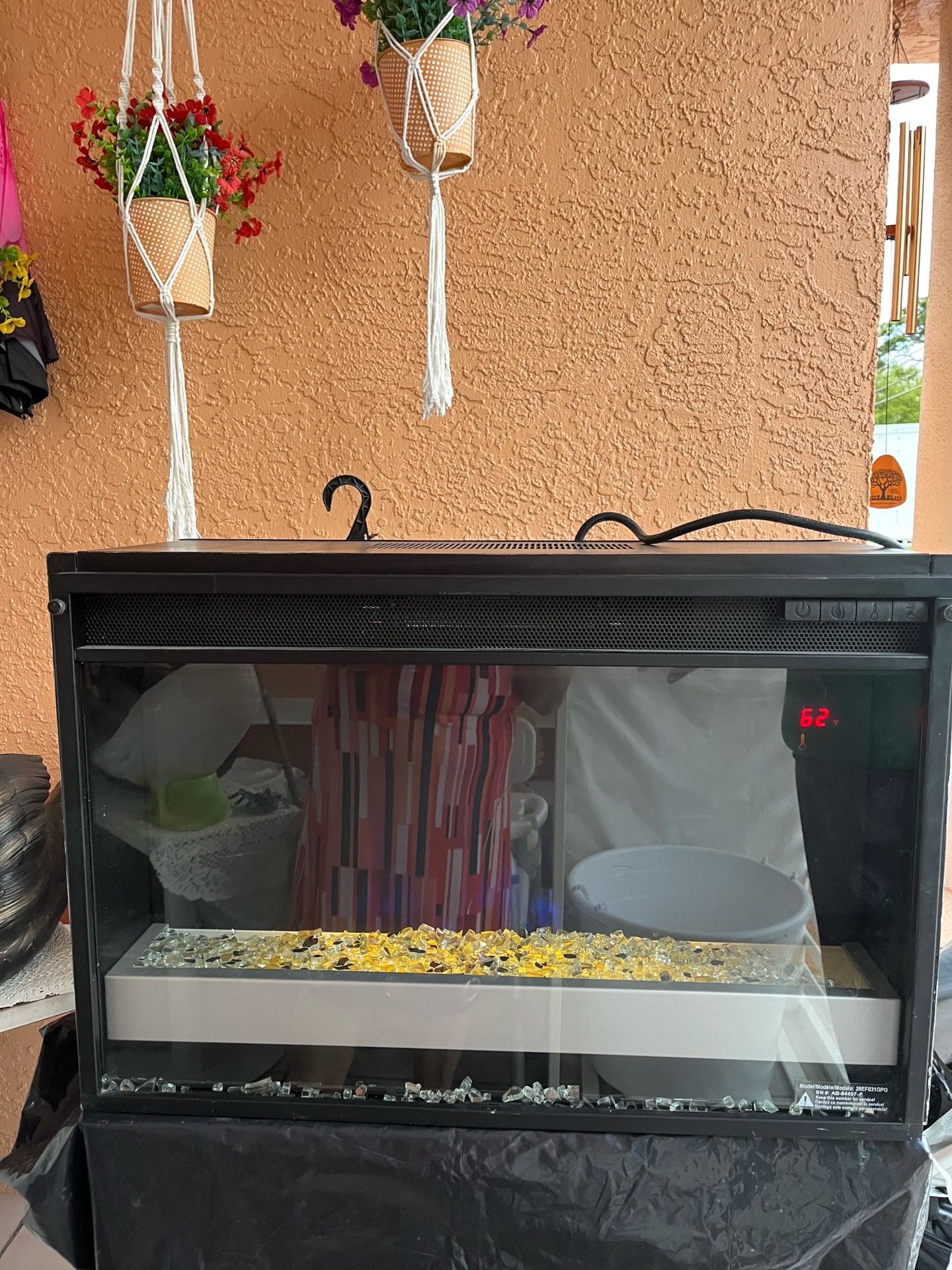 A fireplace in good condition—very attractive and heats very well. Designed for wall installation; it measures 27 inches in length, 9 1/2 inches in wi