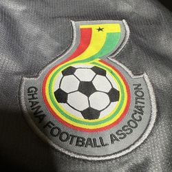 Ghana national football team home jersey, likely the 2018 edition, featuring the Black Star of Africa emblem and the national colors in the design. 
