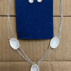 Silver toned Y-drop multi-strand necklace with clear rhinestones and matching earrings.