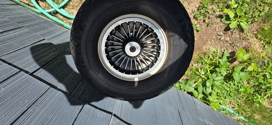 Golf cart wheels and tires with rims.