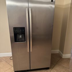 Good Condition ~26 Ft.³ side-by-side stainless steel Kenmore refrigerator with indoor ice and water dispenser