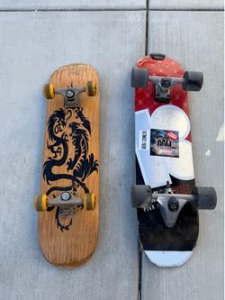 Two skateboards one of them is a Surf skate