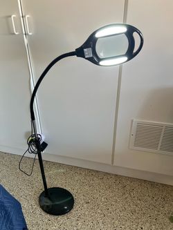 Magnifying glass with light on stand