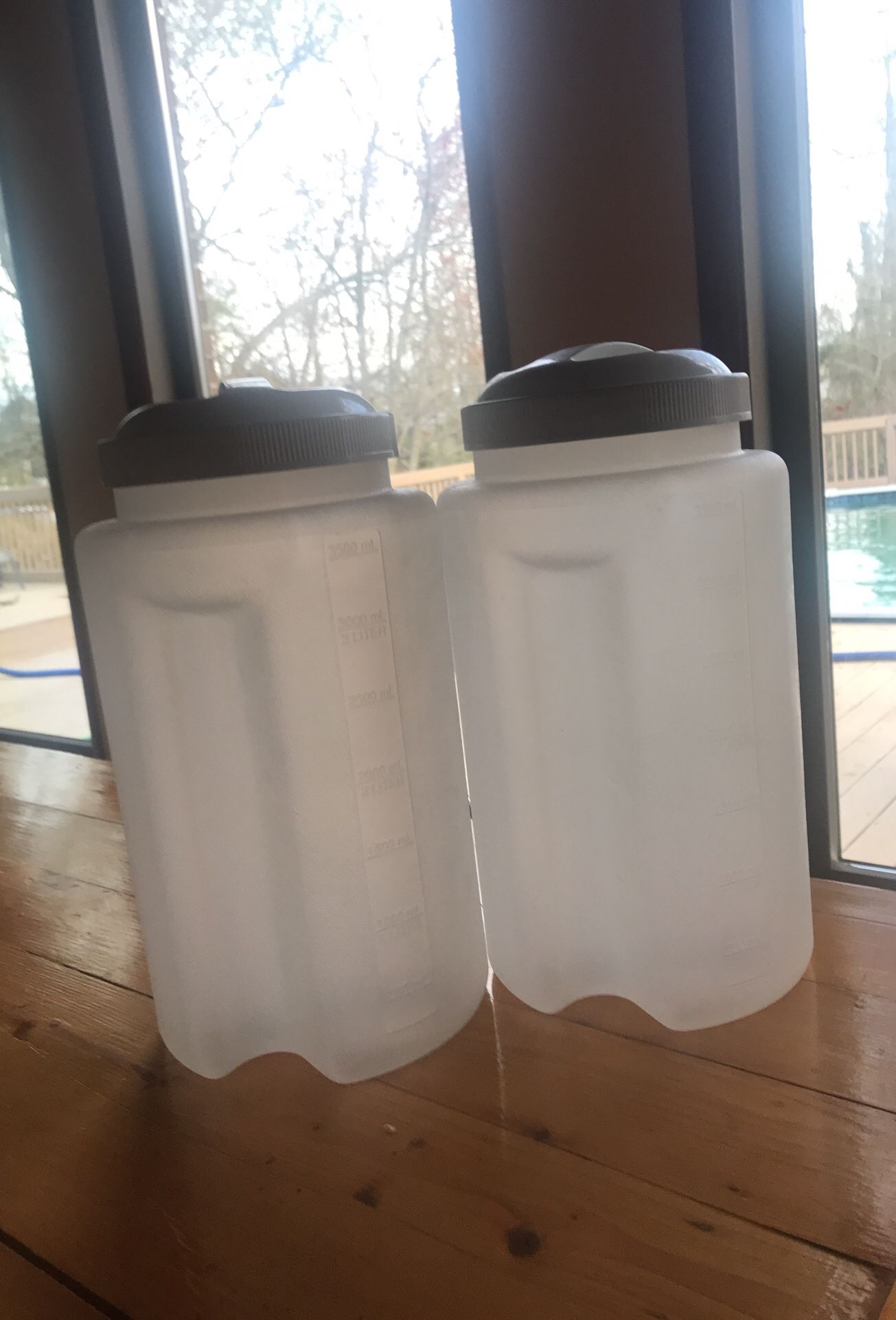 2 plastic one gallon storage containers.