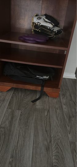 Wood shelf with holes for cords and storage