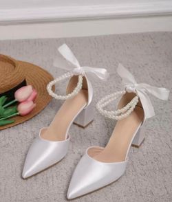 chunky block heel and a delicate pearl strap