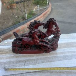 Decorative red horse figurine with intricate details.