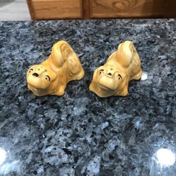 Vintage Pottery Brown Dog Figurines Pair of Salt and Pepper Shakers.  The bottom has Japan stamped on it in red.  Preowned No stoppers.  See pictures.