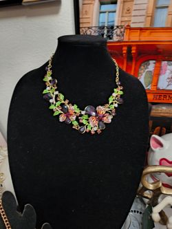 Flower branded glass necklace