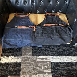 BARBEQUE APRONS WITH LEATHER STRAPS GOOD CONDITION. $7 EACH