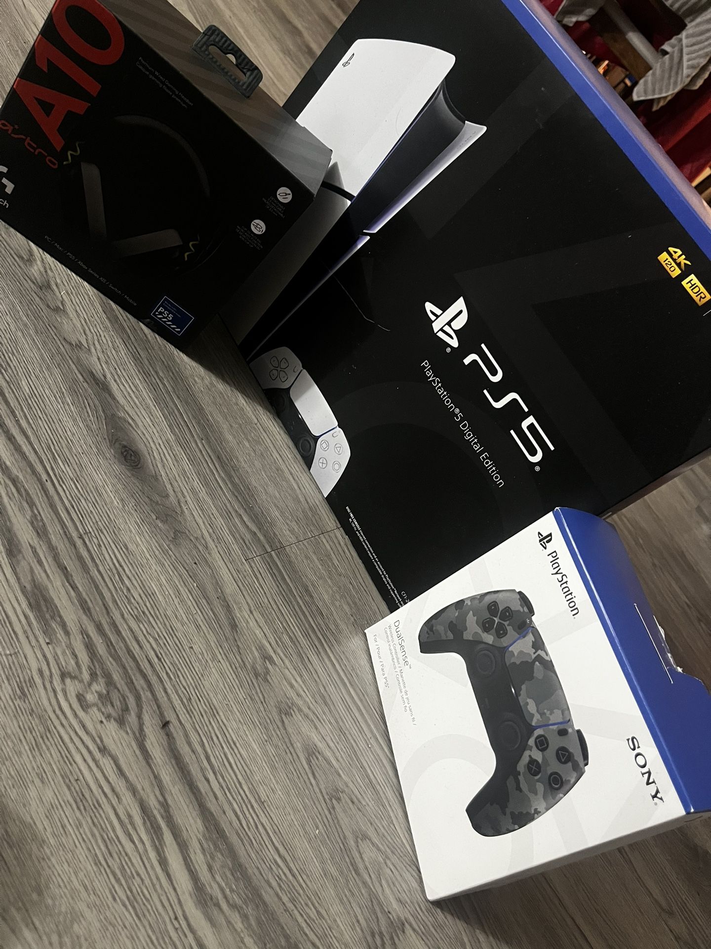 ps5 with astro headphones and a camouflage controller