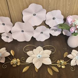 two pink decorations along with a vase